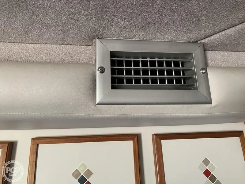 Slide: The Image of Air vent inside 1994 Cruisers Yachts Express Bridge, above decorative cabinet doors. - 36