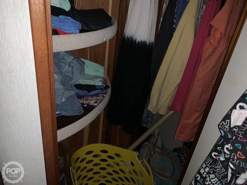 Slide: The Image of Closet storage in 1994 Cruisers Yachts Express Bridge with clothes and laundry basket. - 39