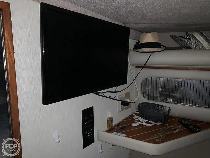 Slide: The Image of Interior of 1994 Cruisers Yachts Express Bridge with mounted TV and storage shelf. - 40