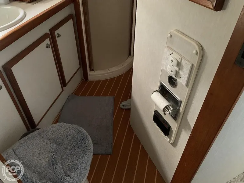 Slide: The Image of 1994 Cruisers Yachts Express Bridge bathroom with wooden flooring and storage cabinets. - 44