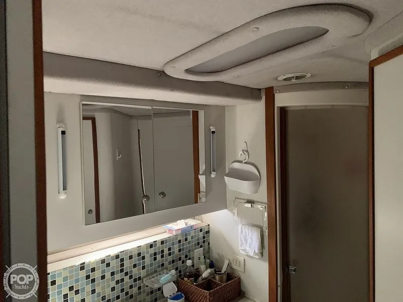 Slide: The Image of Bathroom interior of a 1994 Cruisers Yachts Express Bridge with modern fixtures. - 46
