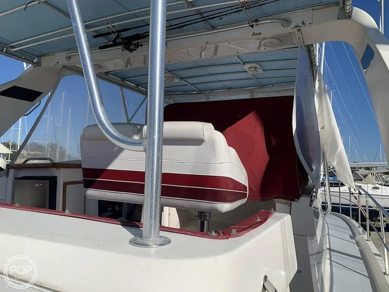 Slide: The Image of 1994 Cruisers Yachts Express Bridge with red and white seating on deck. - 5