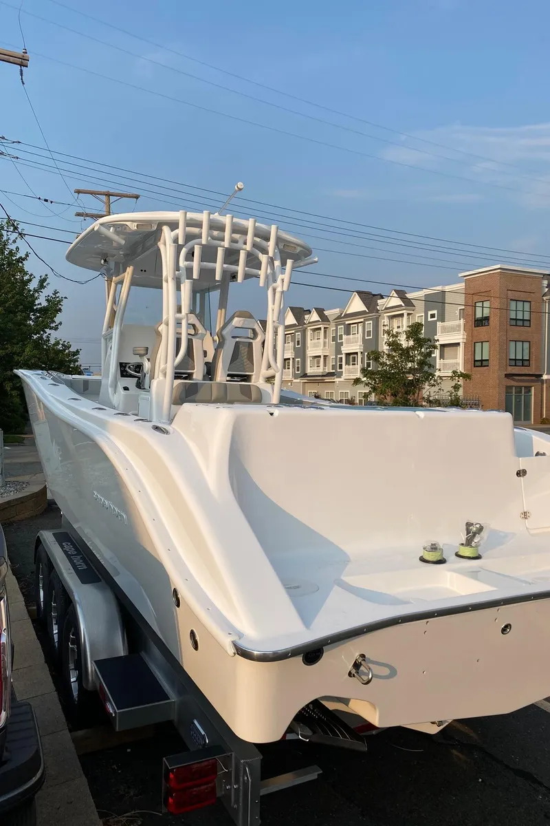 Slide: The Image of 2024 Cape Horn 34 XS boat on trailer in residential area. - 1