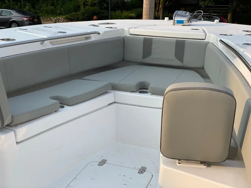 Slide: The Image of 2024 Cape Horn 34 XS boat with spacious seating area and cushioned benches. - 10