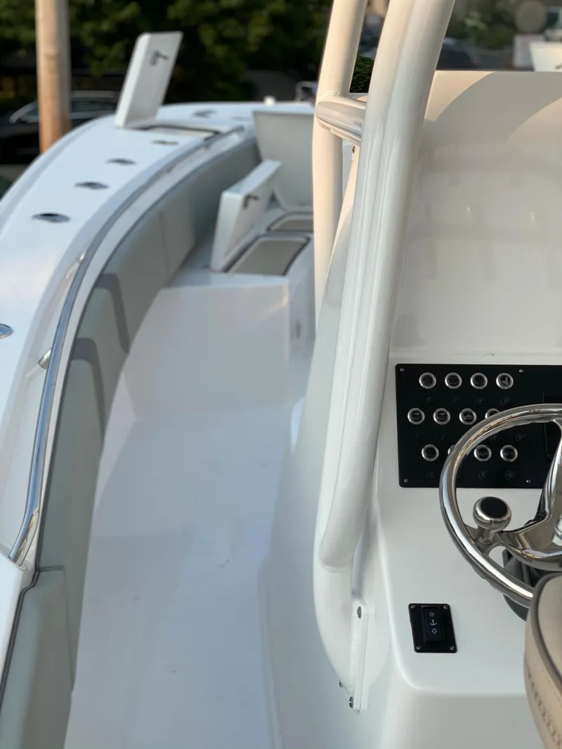 Slide: The Image of 2024 Cape Horn 34 XS boat interior with steering wheel and control panel. - 17