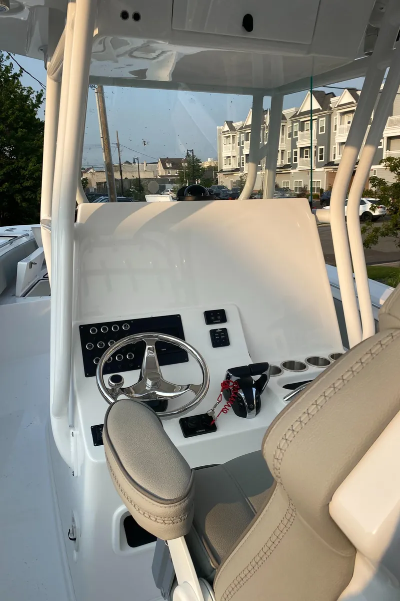 Slide: The Image of 2024 Cape Horn 34 XS boat console with steering wheel and controls. - 19