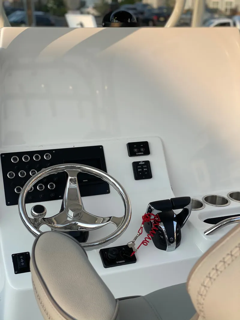 Slide: The Image of 2024 Cape Horn 34 XS boat helm with steering wheel and controls. - 23