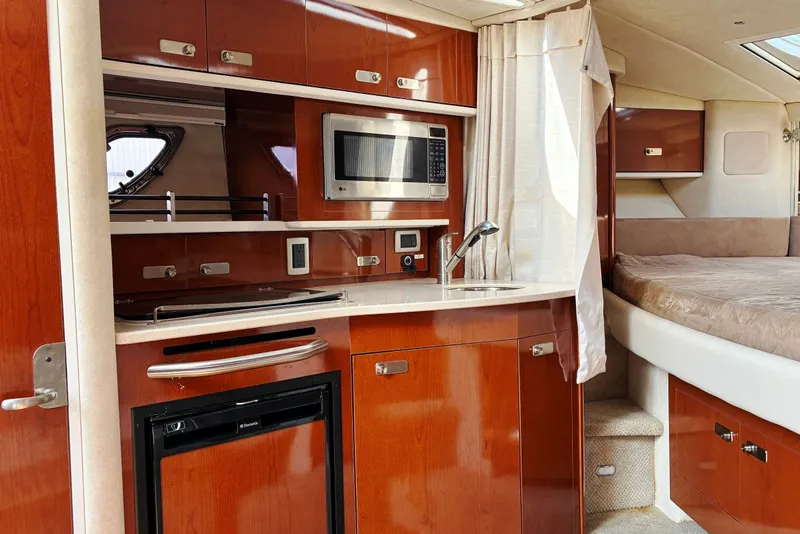 Slide: The Image of Luxurious 2010 Sea Ray Sundancer 330 interior with kitchenette and cozy sleeping area. - 15