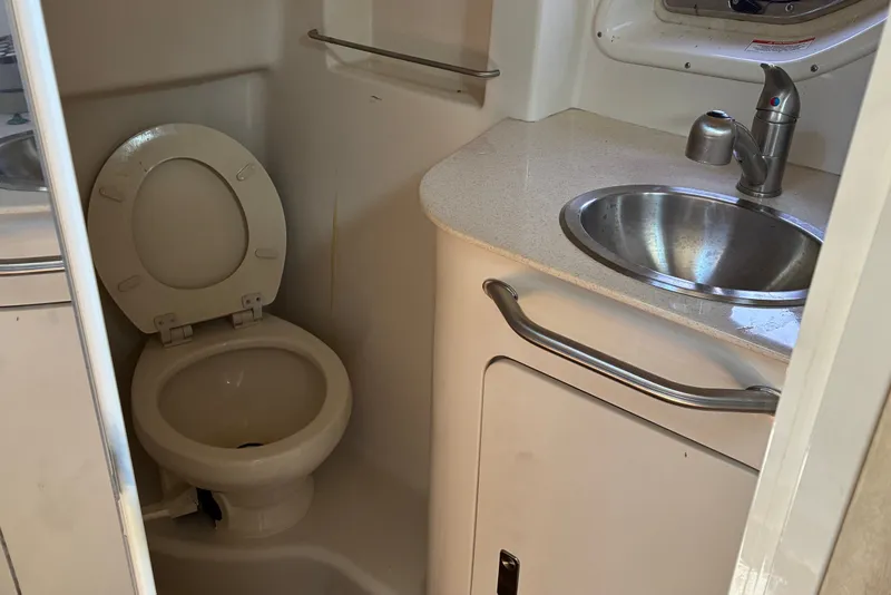 Slide: The Image of Compact bathroom in 2010 Sea Ray Sundancer 330 with toilet and stainless steel sink. - 19