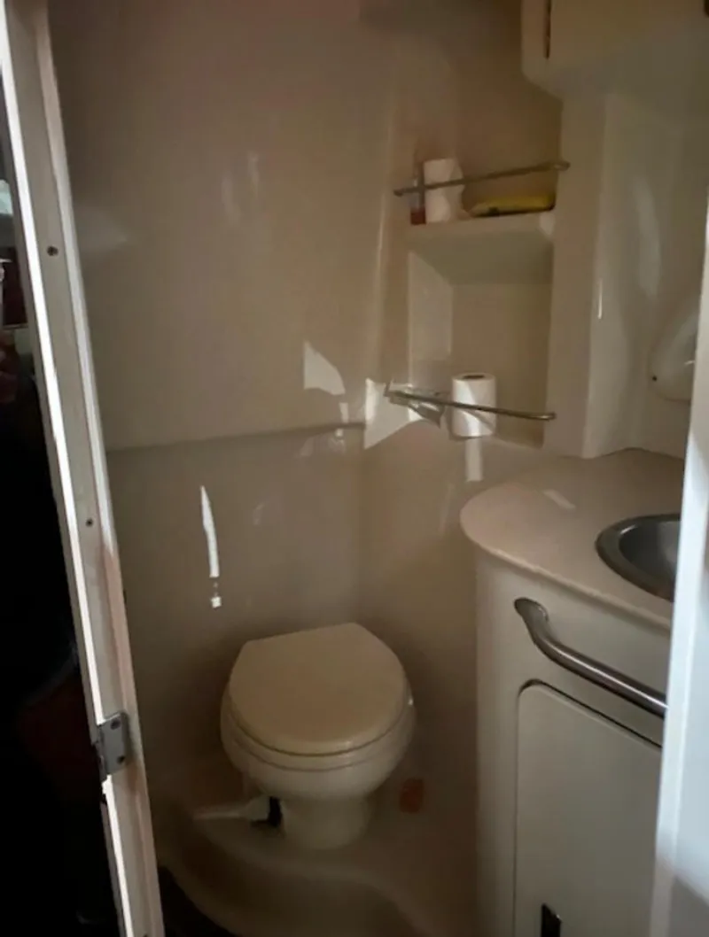 Slide: The Image of The image shows a boat bathroom with a toilet, sink, and shelving. - 18