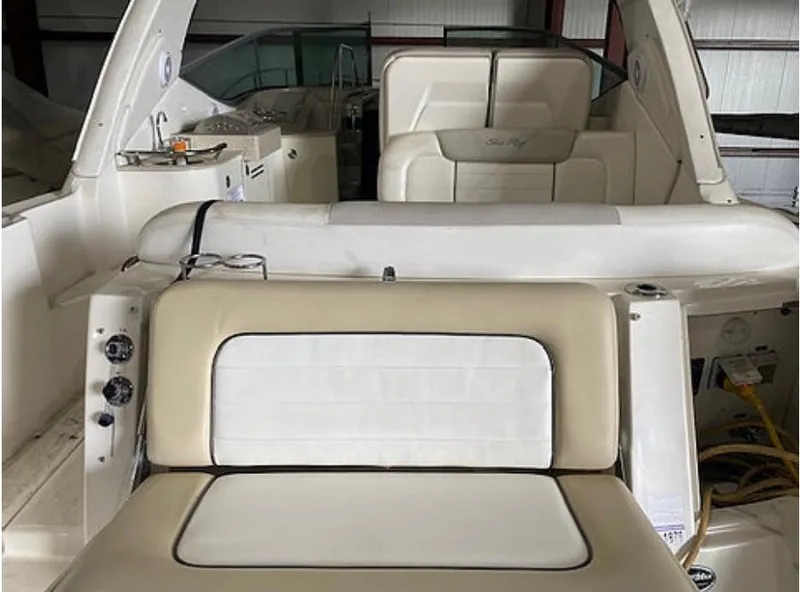 Slide: The Image of The image shows the cockpit of a 2010 Sea Ray Sundancer 330 with beige and white seating. - 13