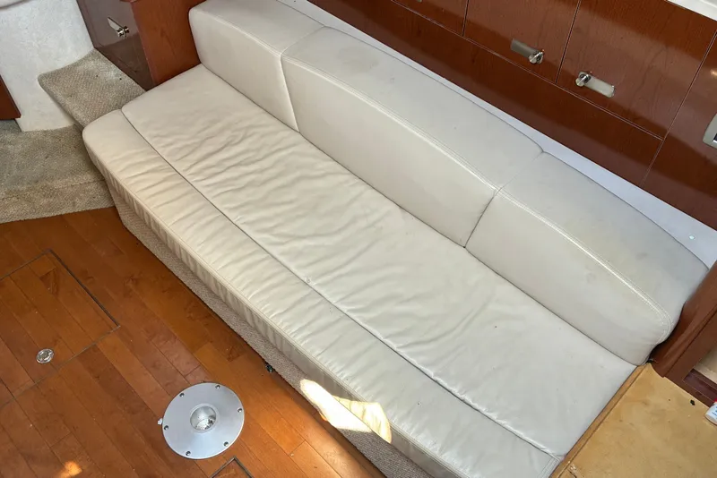 Slide: The Image of Cream leather sofa in 2010 Sea Ray Sundancer 330 cabin, with wooden flooring. - 16