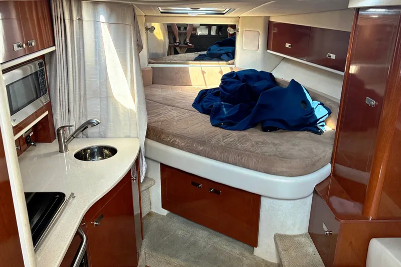 Slide: The Image of Interior of 2010 Sea Ray Sundancer 330 yacht with cozy bed and kitchenette. - 14