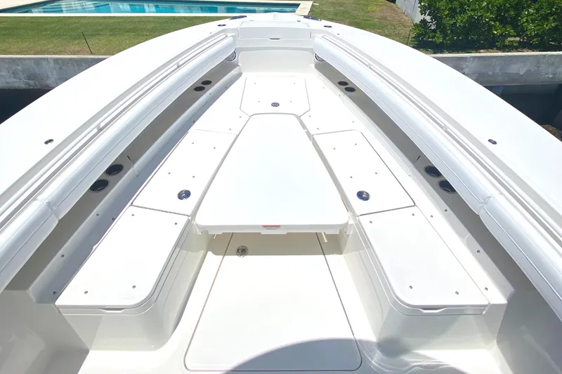 Slide: The Image of 2020 Regulator 31 boat interior with white seating and storage compartments. - 10