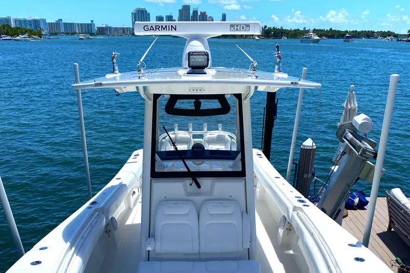 Slide: The Image of 2020 Regulator 31 boat docked with Garmin radar, city skyline in background. - 13