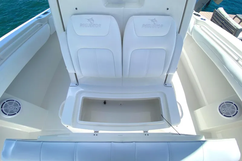 Slide: The Image of 2020 Regulator 31 boat with white seating and storage compartment. - 18