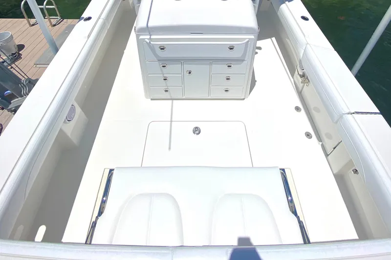 Slide: The Image of 2020 Regulator 31 boat interior with white seating and storage compartments. - 20