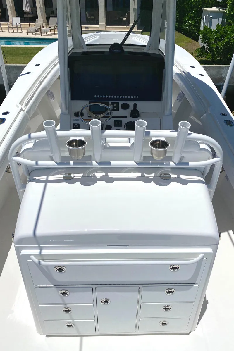 Slide: The Image of 2020 Regulator 31 boat console with rod holders and storage compartments. - 21