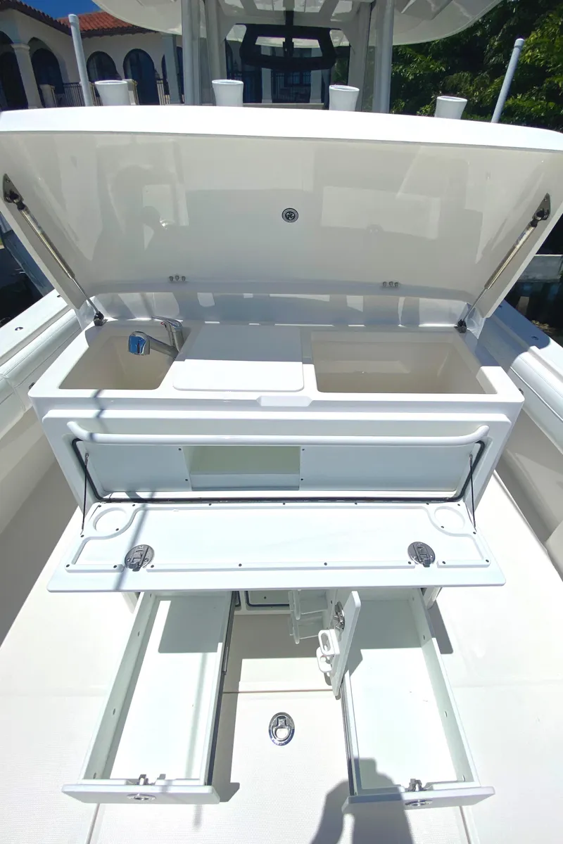 Slide: The Image of 2020 Regulator 31 boat with open storage compartments and work area. - 24