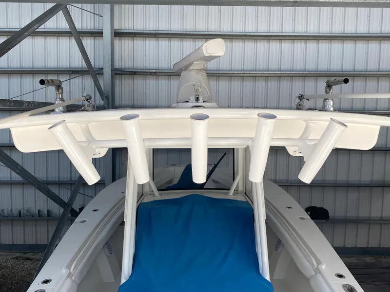 Slide: The Image of 2020 Regulator 31 boat with rod holders and blue cover. - 25