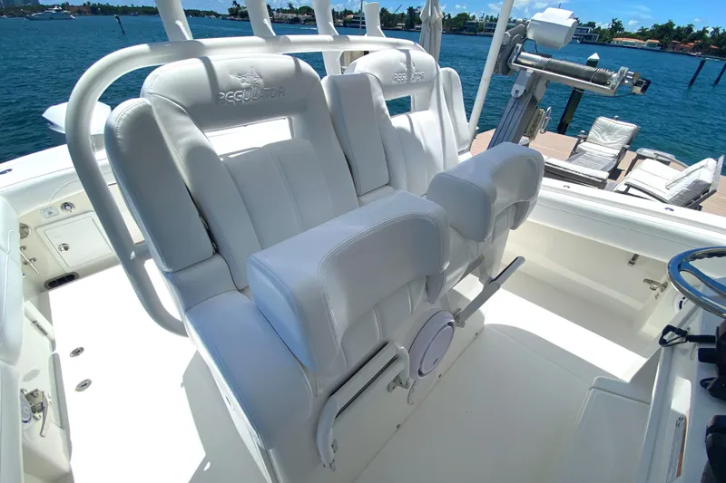 Slide: The Image of 2020 Regulator 31 boat with white cushioned seats and ocean view. - 30