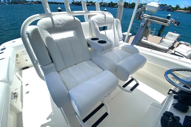 Slide: The Image of 2020 Regulator 31 boat with white captain's chairs and ocean view. - 31