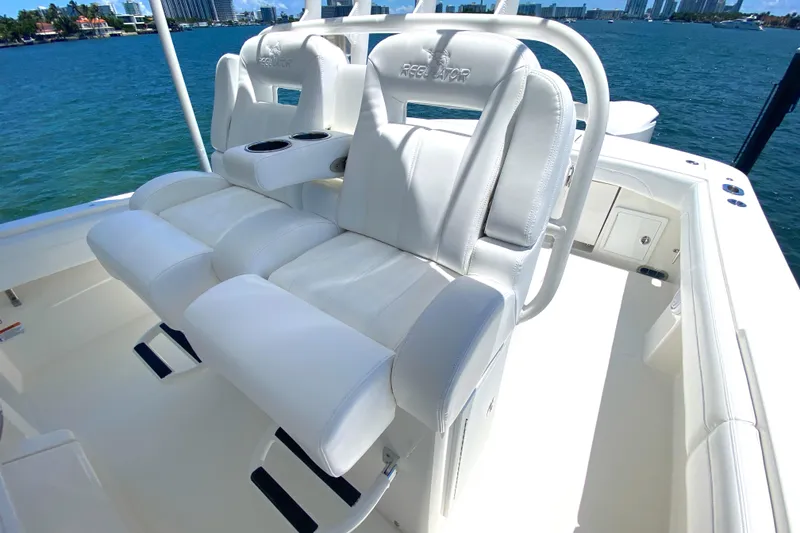 Slide: The Image of 2020 Regulator 31 boat with white cushioned seating and ocean backdrop. - 32