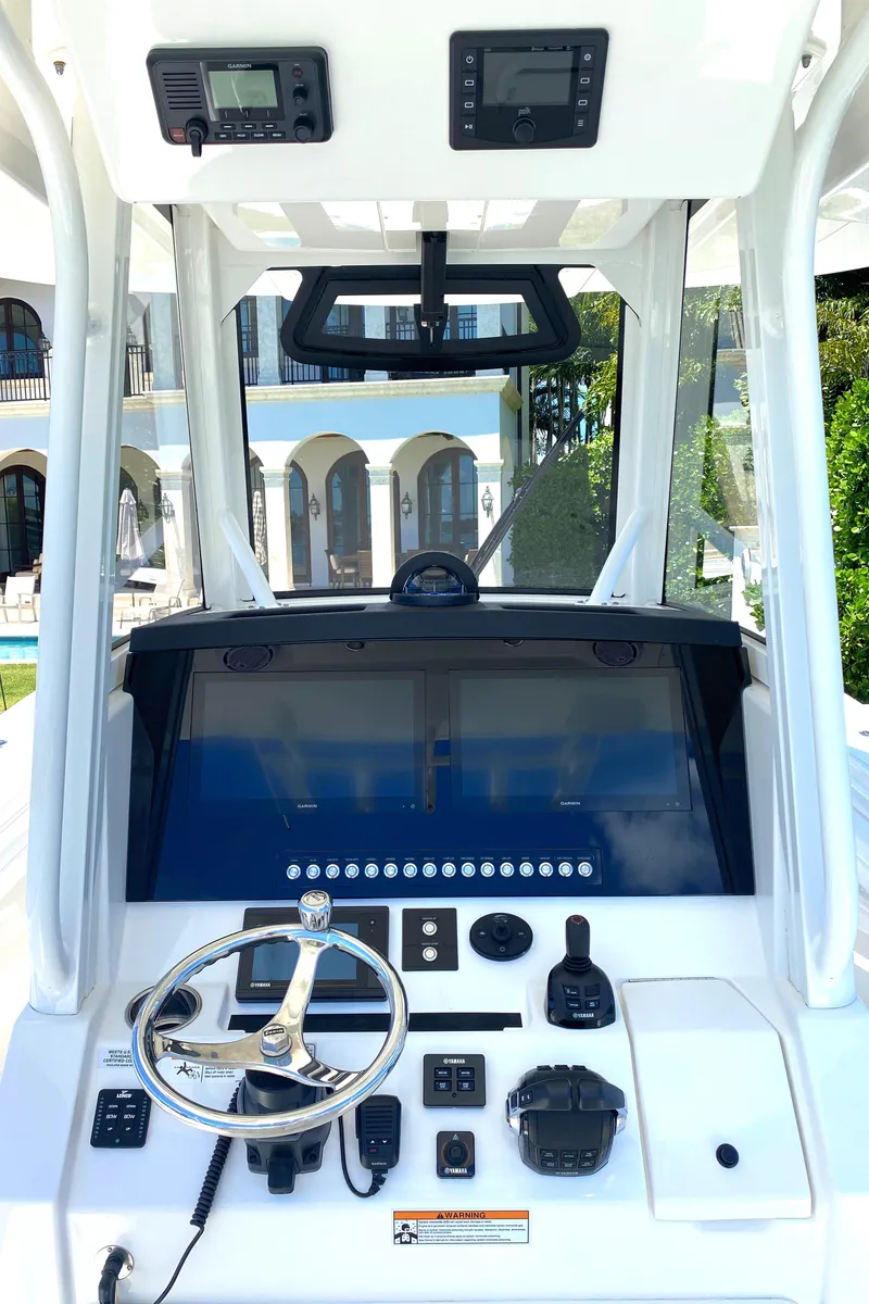 Slide: The Image of 2020 Regulator 31 boat dashboard with steering wheel and electronic controls. - 33