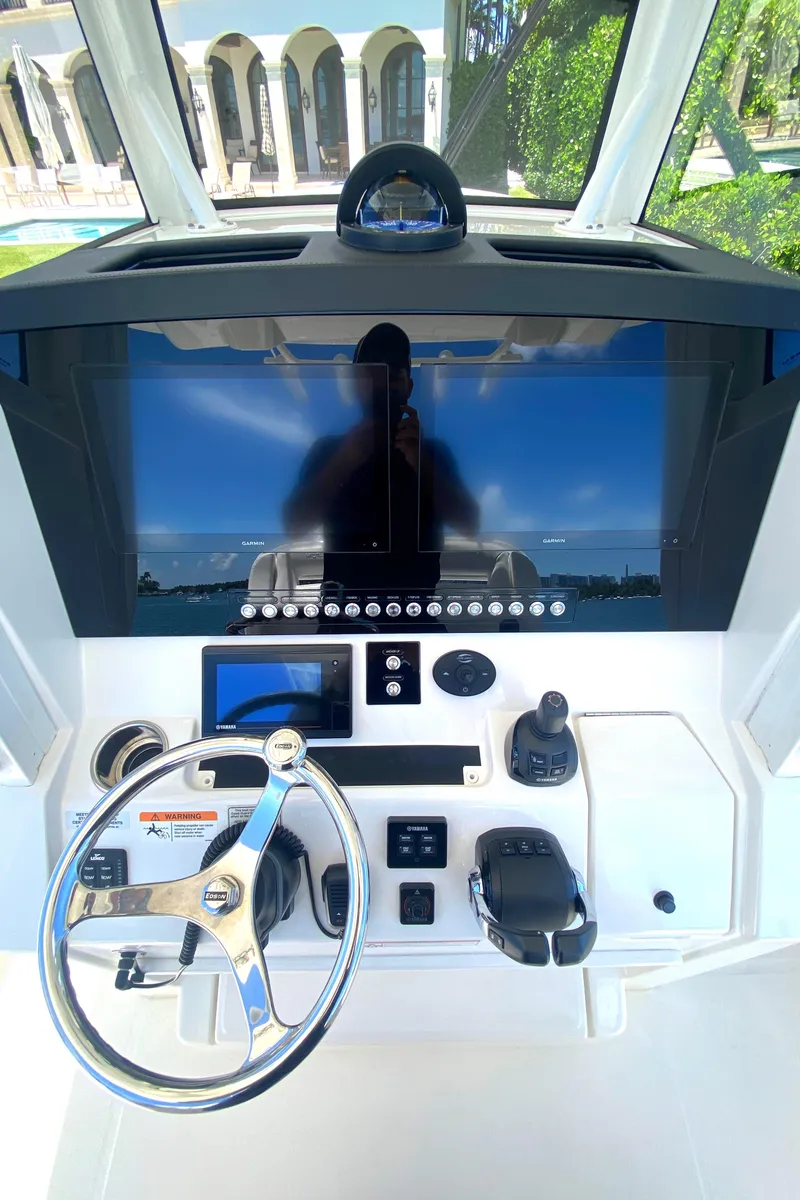 Slide: The Image of 2020 Regulator 31 boat helm with modern controls and large display screen. - 36
