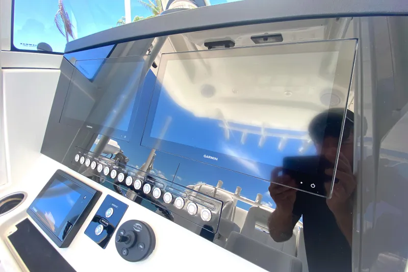 Slide: The Image of 2020 Regulator 31 boat dashboard with modern navigation screens. - 37