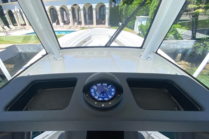 Slide: The Image of 2020 Regulator 31 boat helm with compass, luxury waterfront view. - 39