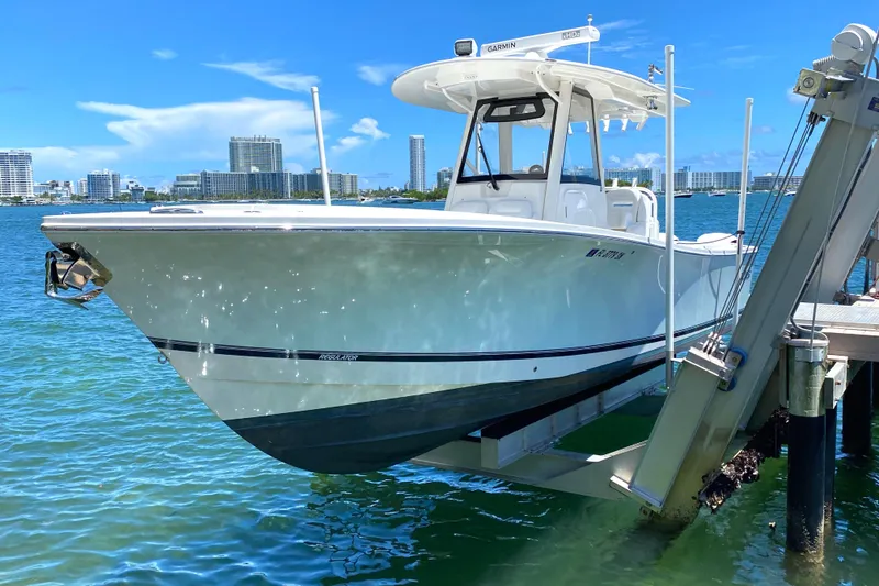 Slide: The Image of 2020 Regulator 31 boat docked on a lift in a marina. - 6