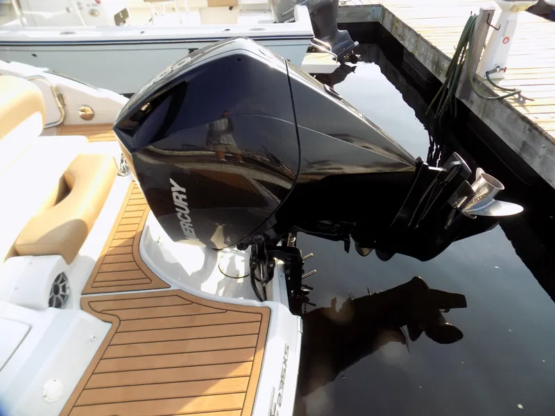 Slide: The Image of 2020 Crownline Eclipse E235 XS with Mercury outboard engine, docked on wooden platform. - 12