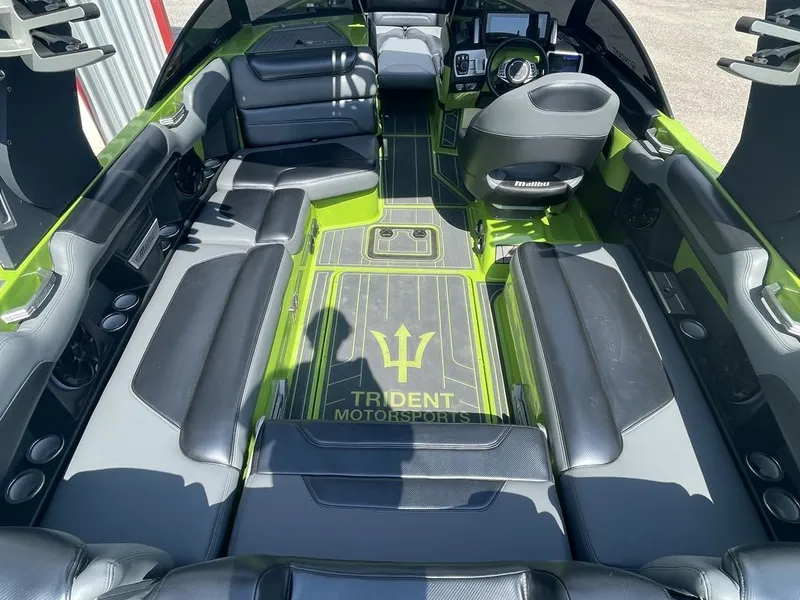 Slide: The Image of Interior of a 2016 Malibu M235 boat with black and green seating. - 5