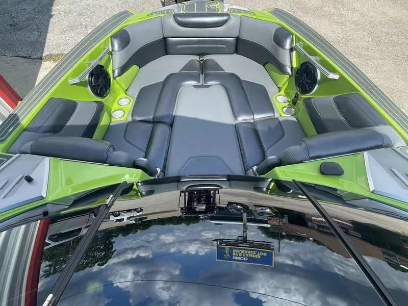 Slide: The Image of 2016 Malibu M235 boat interior with green and black seating. - 6