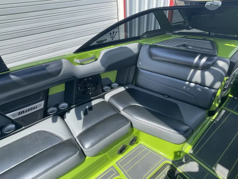 Slide: The Image of 2016 Malibu M235 boat interior with black and green seating. - 9