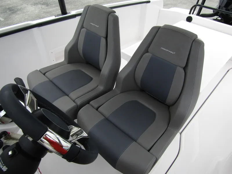 Slide: The Image of 2022 Axopar 22 T-Top boat seats and steering wheel, featuring modern design and comfort. - 12