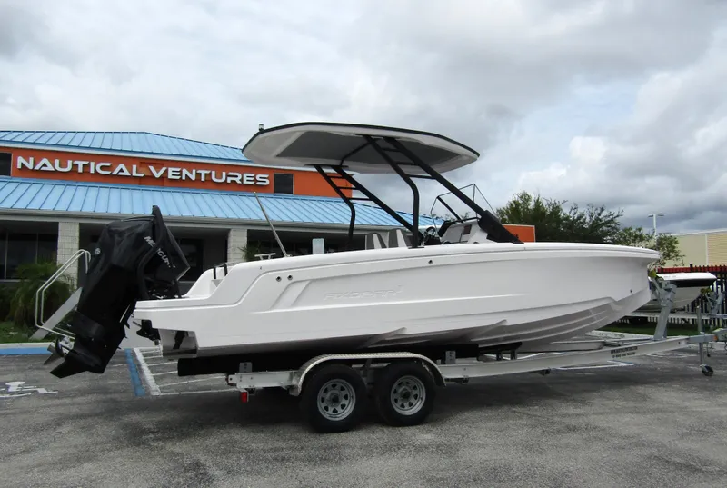 Slide: The Image of 2022 Axopar 22 T-Top boat on trailer outside Nautical Ventures store. - 2