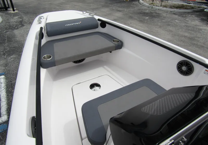 Slide: The Image of 2022 Axopar 22 T-Top boat interior with seating and cup holders. - 8