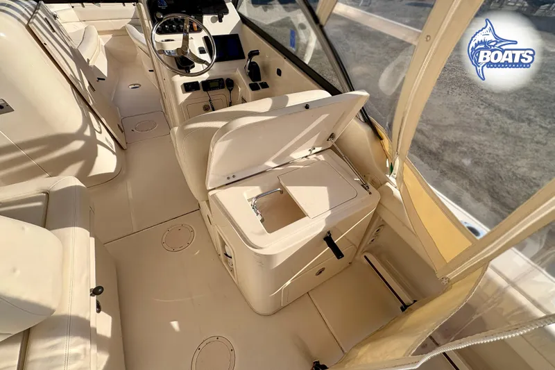 Slide: The Image of 2016 Grady-White Freedom 255 boat interior with helm and seating area. - 10