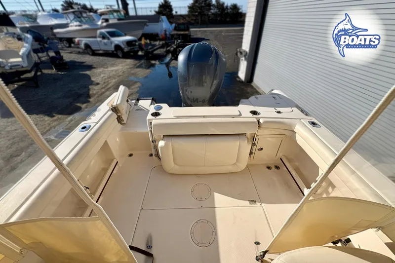 Slide: The Image of 2016 Grady-White Freedom 255 boat interior with seating and motor, displayed outdoors. - 12