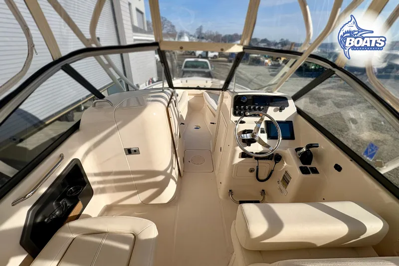 Slide: The Image of Interior view of 2016 Grady-White Freedom 255 boat, featuring helm and seating area. - 8