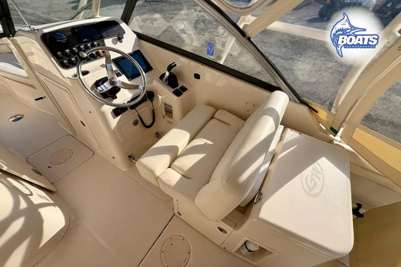 Slide: The Image of 2016 Grady-White Freedom 255 boat interior with steering wheel and control panel. - 9