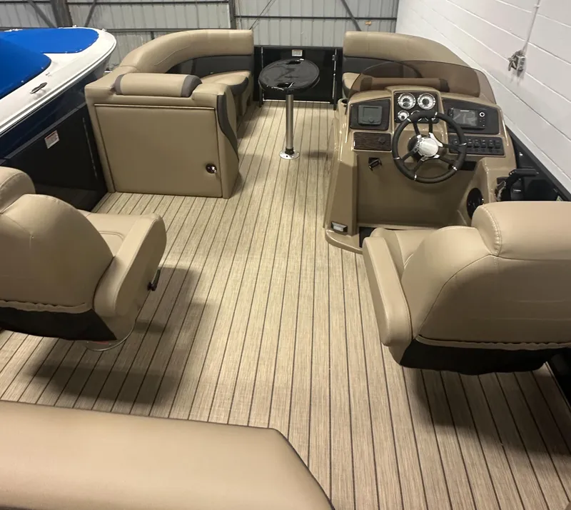 Slide: The Image of Interior of 2025 Sylvan MIRAGE X1 CLZ DH boat with beige seating and modern dashboard. - 11