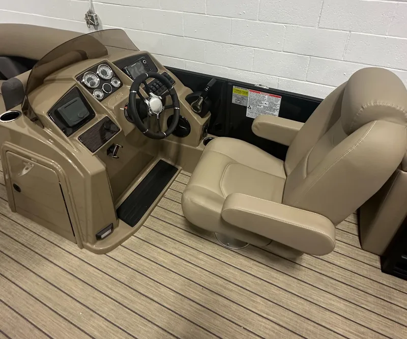 Slide: The Image of 2025 Sylvan MIRAGE X1 CLZ DH boat interior with beige captain's chair and control panel. - 14
