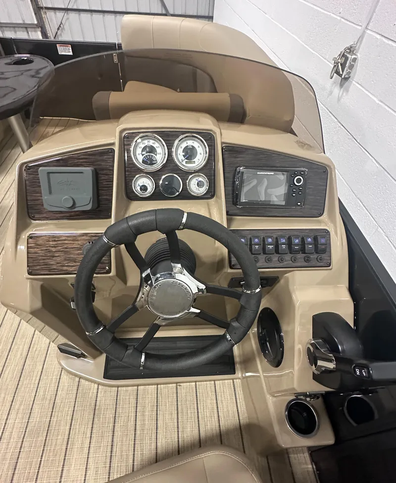 Slide: The Image of 2025 Sylvan MIRAGE X1 CLZ DH boat dashboard with steering wheel and control panels. - 15