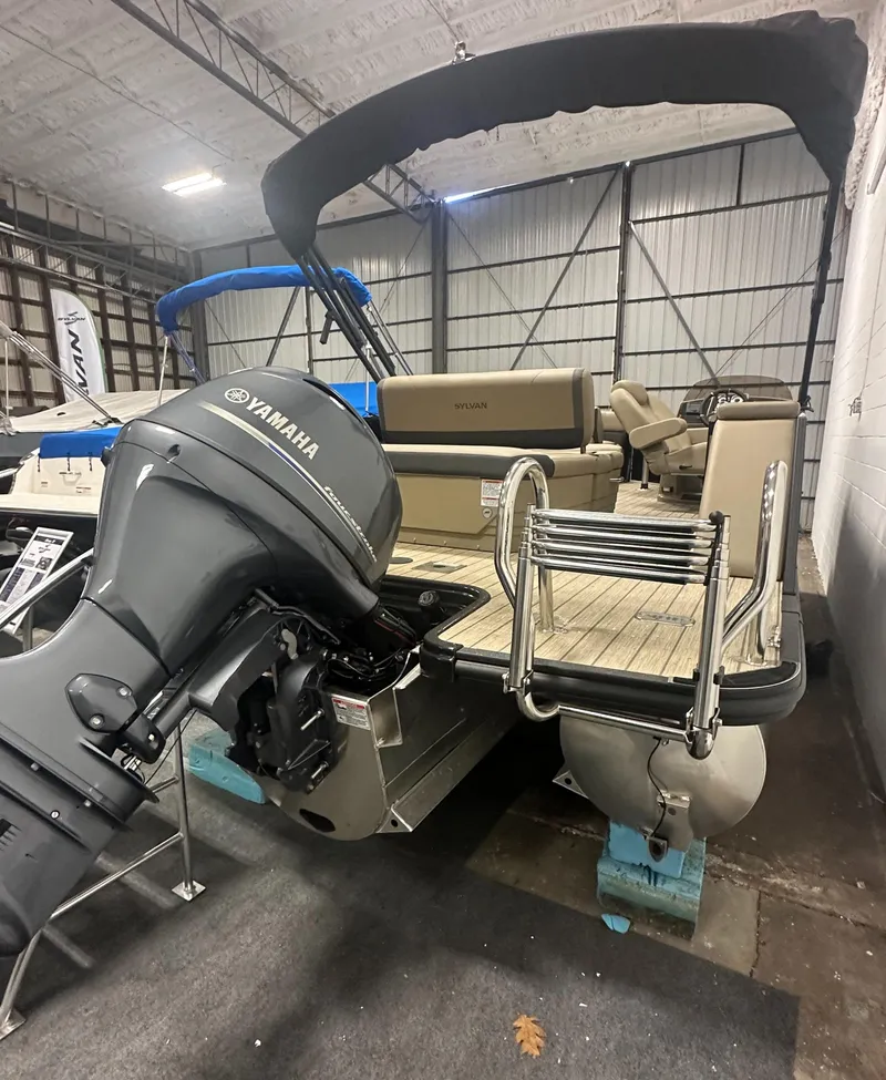 Slide: The Image of 2025 Sylvan MIRAGE X1 CLZ DH pontoon boat with Yamaha motor in a warehouse. - 3