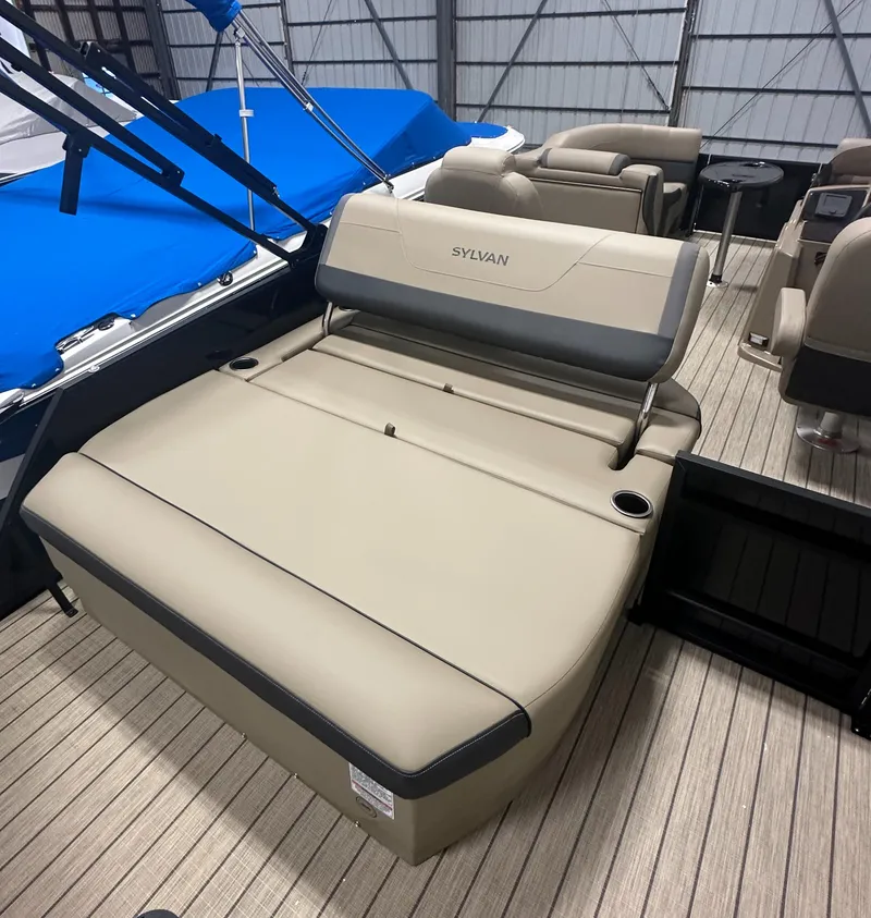 Slide: The Image of 2025 Sylvan MIRAGE X1 CLZ DH boat interior with beige seating and wood flooring. - 6