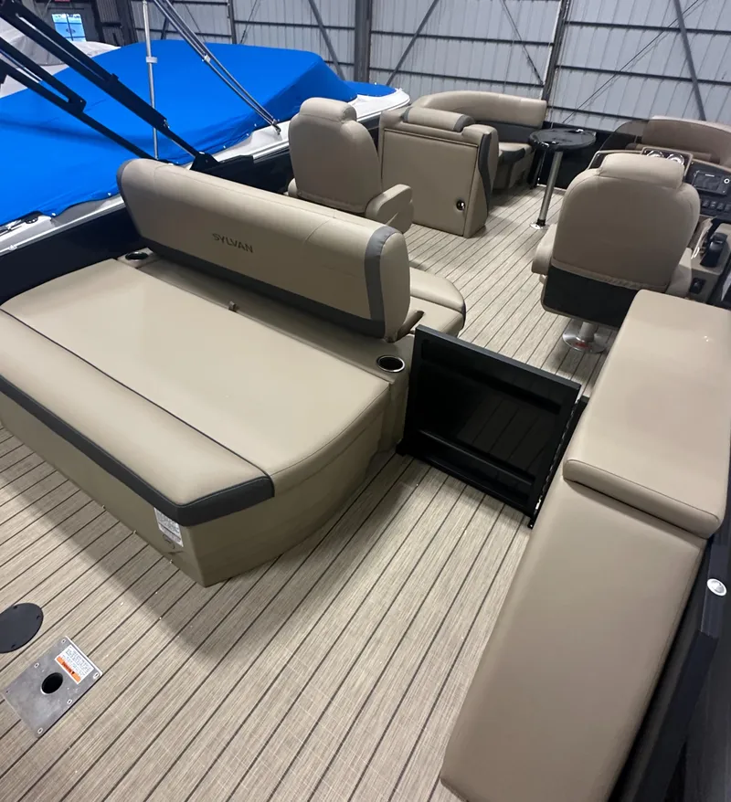 Slide: The Image of 2025 Sylvan MIRAGE X1 CLZ DH pontoon boat interior with beige seating and wood flooring. - 7