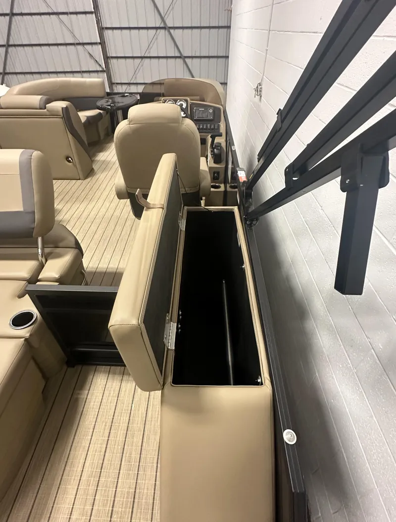 Slide: The Image of 2025 Sylvan MIRAGE X1 CLZ DH boat interior with beige seating and storage compartment. - 9